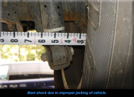 Bent shock due to improper jacking of vehicle. 